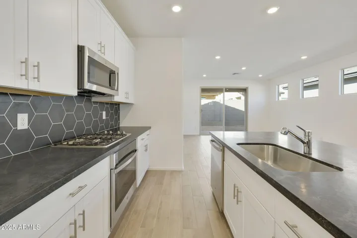 COMES WITH PAINTED CABINETS, QUARTZ COUNTERS, DESIGNER BACKSPLASH, GOURMET KITCHEN PHOTOS ARE OF ANOTHER HOME WITH SIMILAR SELECTIONS.