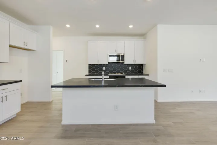 COMES WITH PAINTED CABINETS, QUARTZ COUNTERS, DESIGNER BACKSPLASH, GOURMET KITCHEN PHOTOS ARE OF ANOTHER HOME WITH SIMILAR SELECTIONS.