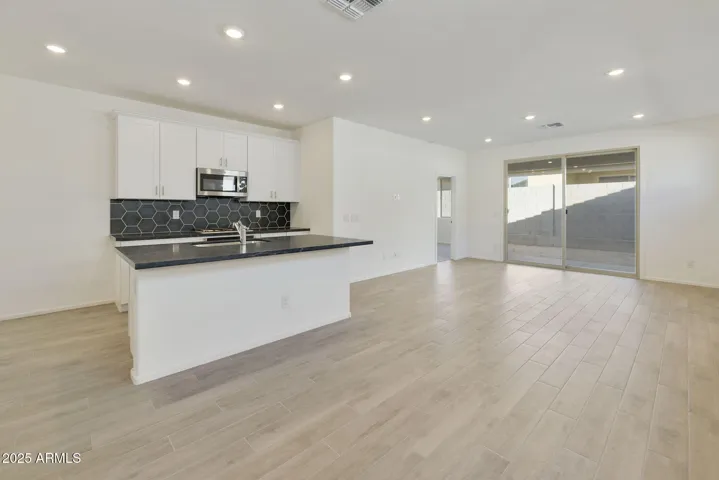 BEAUTIFUL WOOD PLANK TILE FLOORING THROUGH OUT EXCEPT FOR THE BEDROOMS