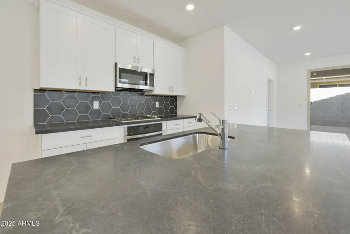 COMES WITH PAINTED CABINETS, QUARTZ COUNTERS, DESIGNER BACKSPLASH, GOURMET KITCHEN PHOTOS ARE OF ANOTHER HOME WITH SIMILAR SELECTIONS.