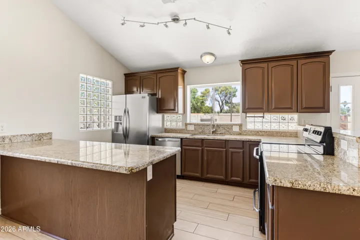 Nicely finishes kitchen with granite counters and newer appliances