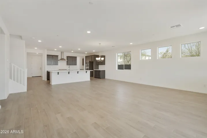 LARGE GREAT ROOM WITH SEEMLESS WOOD PLANK TILE THROUGHOUT.