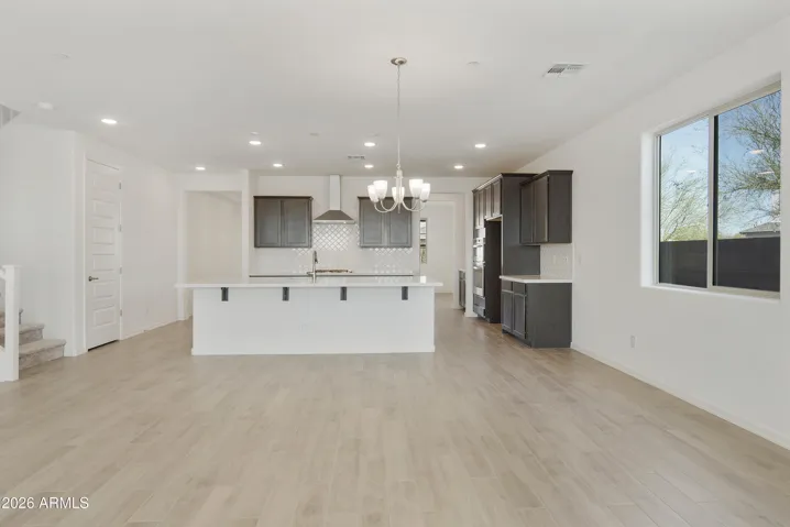 GOURMET KITCHEN WITH BUILT IN APPLINACES. DESIGNER BACKSPLASH, DESIGNER HOOD, GAS COOKTOP AND QUARTZ COUNTERS.
