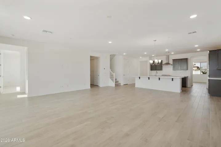LARGE GREAT ROOM WITH SEEMLESS WOOD PLANK TILE THROUGHOUT.