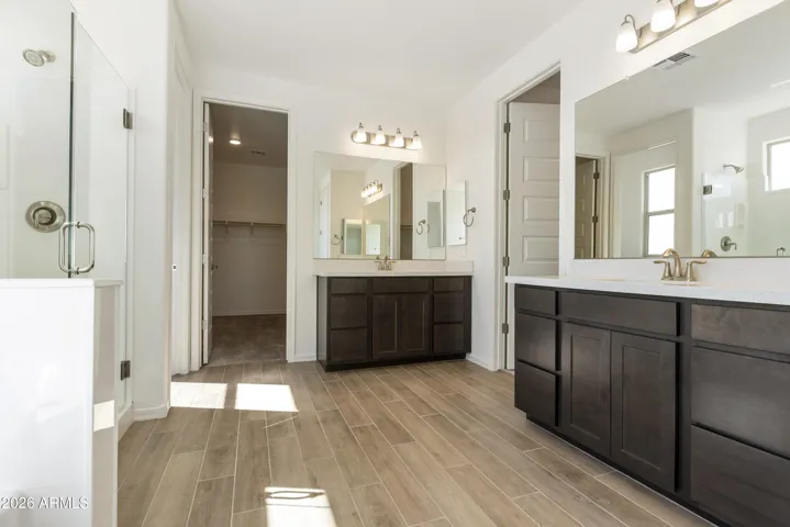 SEPARATE TUB AND SHOWER IN THE OWNER'S BATH. HIS AND HER'S CLOSETS AND DUAL VANITIES.