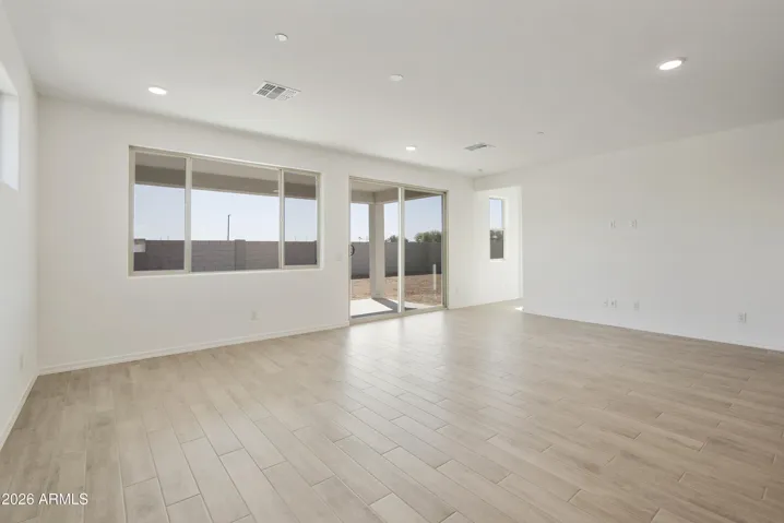 LARGE GREAT ROOM WITH SEEMLESS WOOD PLANK TILE THROUGHOUT.