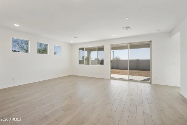 LARGE GREAT ROOM WITH SEEMLESS WOOD PLANK TILE THROUGHOUT.