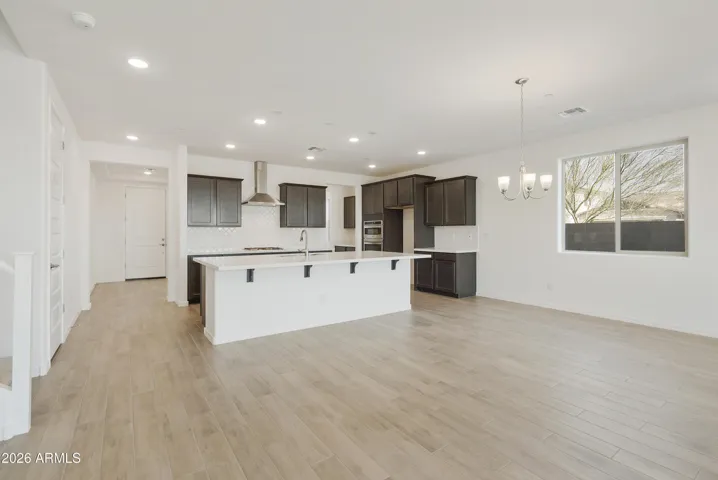 GOURMET KITCHEN WITH BUILT IN APPLINACES. DESIGNER BACKSPLASH, DESIGNER HOOD, GAS COOKTOP AND QUARTZ COUNTERS.