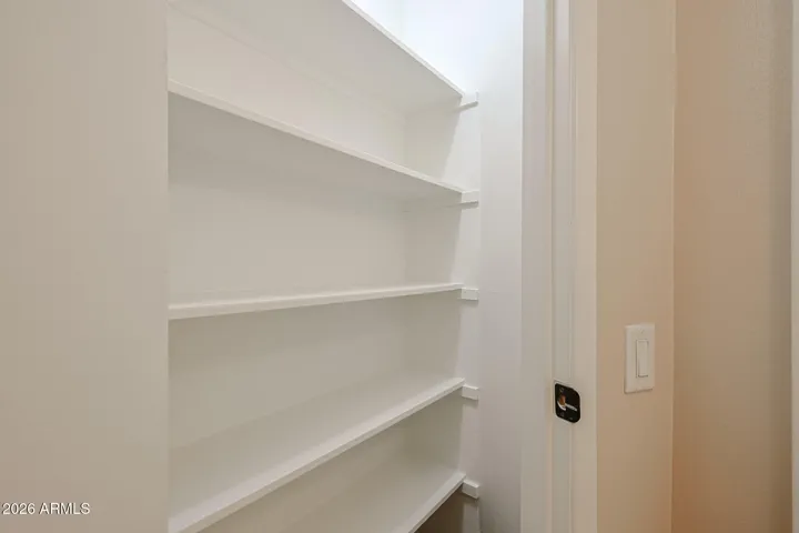 lighted linen closet by bathroom