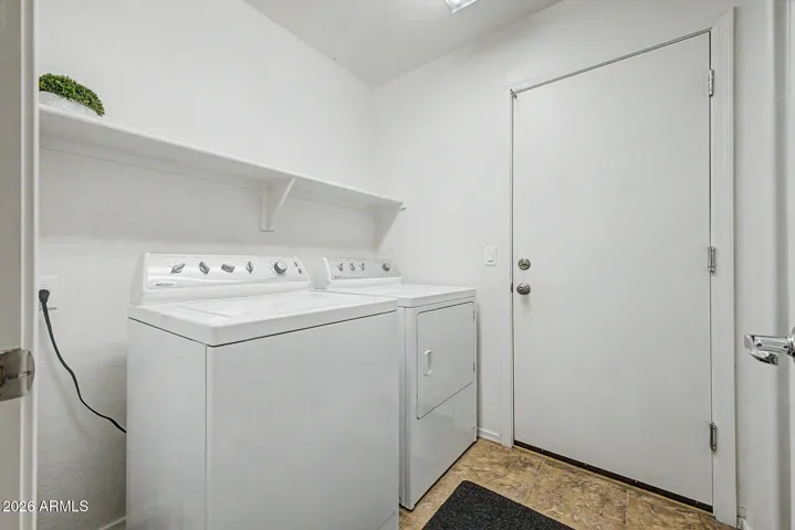 Inside laundry Room with full closet across