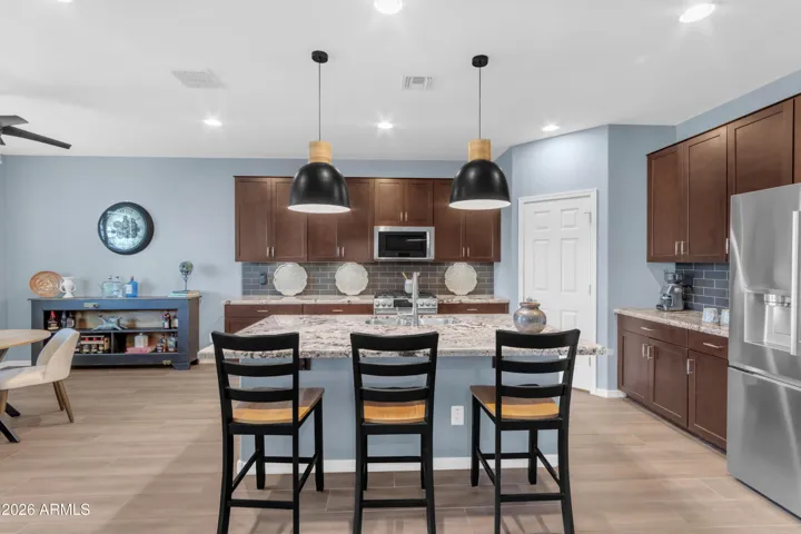 Kitchen has wood cabinets with beautiful granite counters and center island. Eat in the kitchen or in the adjacent nook.