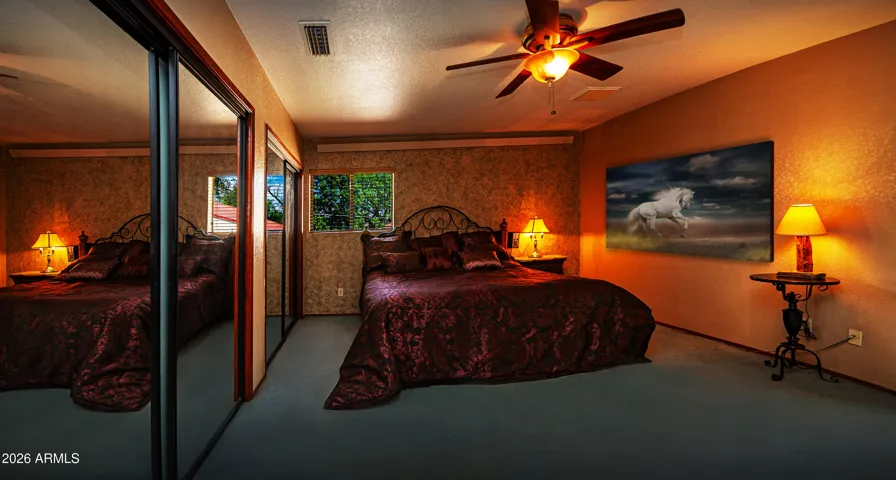 Primary Bedroom has 2 windows and double closets with exit door to adjacent sunroom.