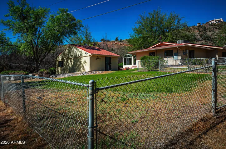 Fenced side yard protects raised garden beds.