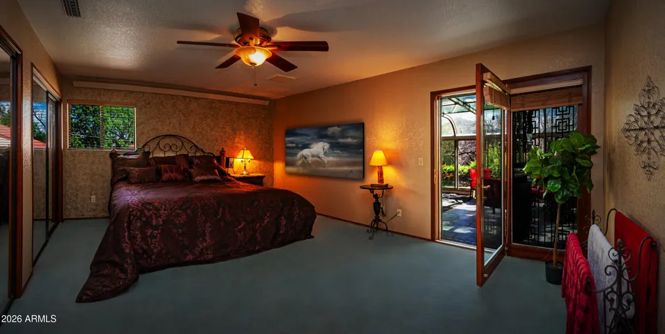 Primary bedroom with sliding door exit to the Sunroom/Sitting room.