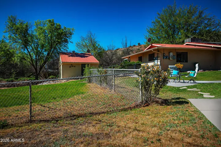 Side yard has raised garden beds for vegetables and flowers.