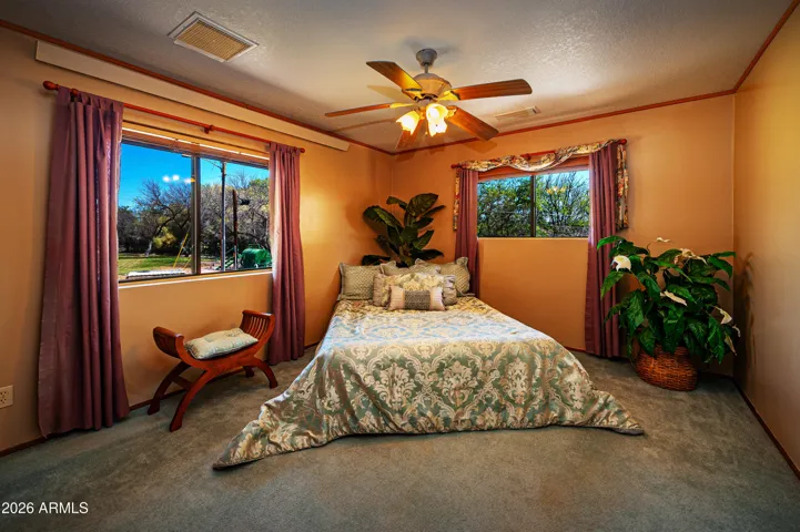 This corner bedroom enjoys views out the 2 windows and has double closets and a ceiling fan & light.