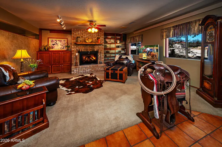 Fireplace, built-in shelves, tiled entry flooring.