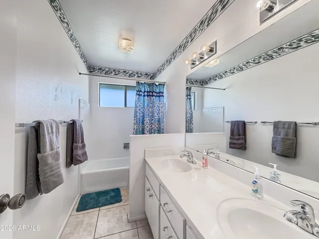 Guest bathroom with dual vanity and shower/tub combo