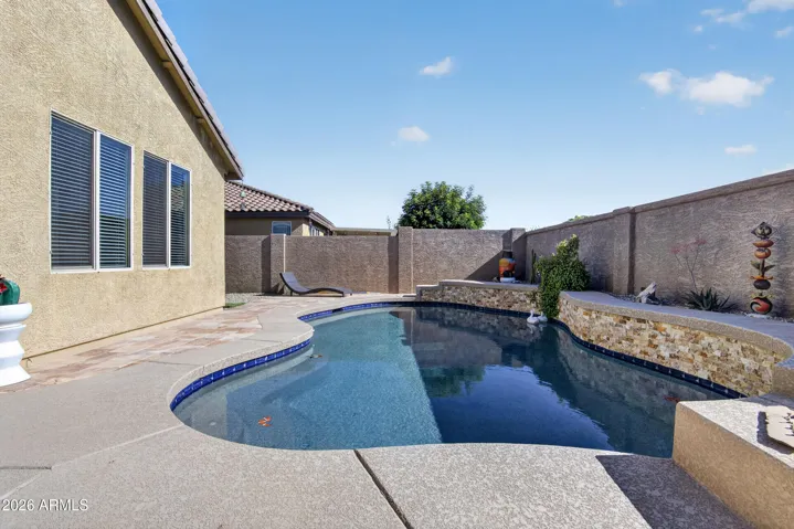 Relaxing pool with beautiful stone 2 water features and cool deck