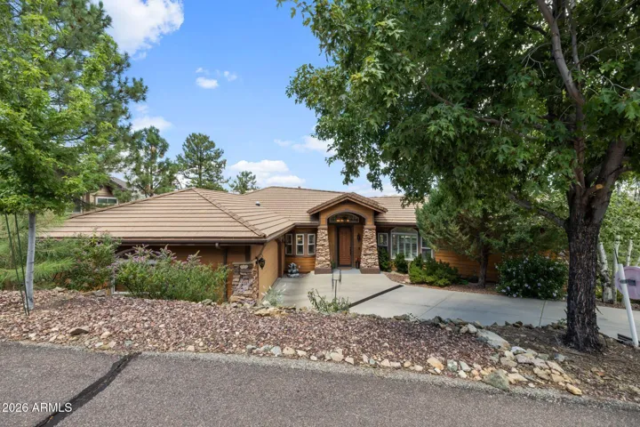 Custom home with cement tile roof and concrete siding.