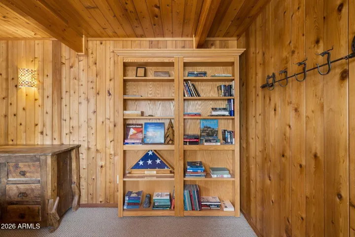 Built in book case that opens up to reveal the elevator entrance behind.