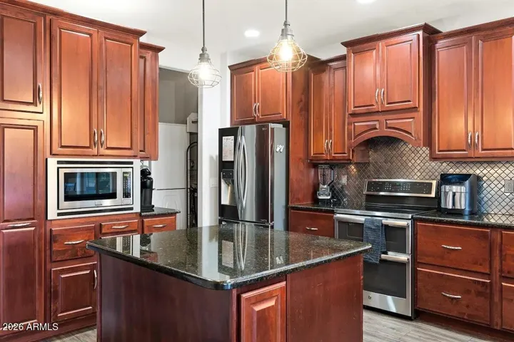 Huge kitchen with custom cherry cabinets, granite countertops, island with storage, two wine refrigerators, SS appliances, an DOUBLE set of washer and dryer!