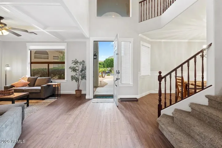 Front door entrance with seating area on left as you enter, formal dining on the right and stairs to head upstairs .
