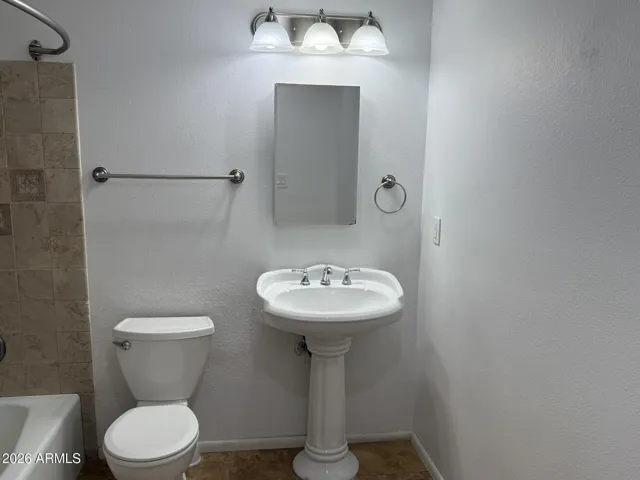 Hall bath is full tub/shower and full tiled surround