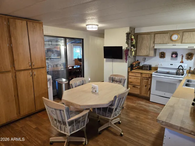 Kitchen with hallway to primary bedroom and dining room