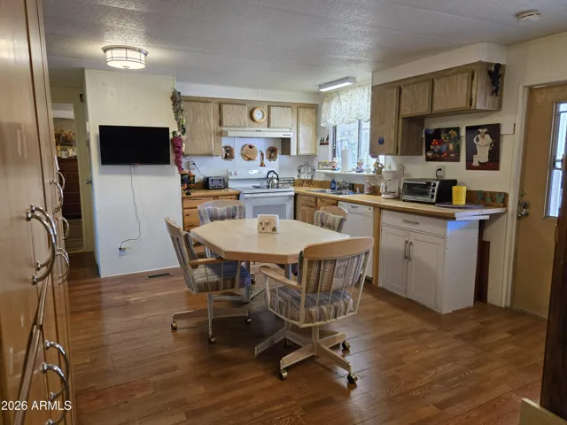 Kitchen, hallway leading to primary bedroom
