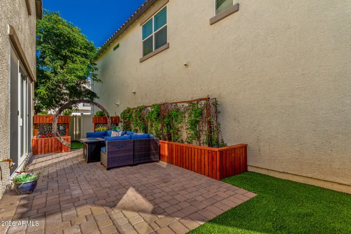 Tiled backyard with green astroturf.