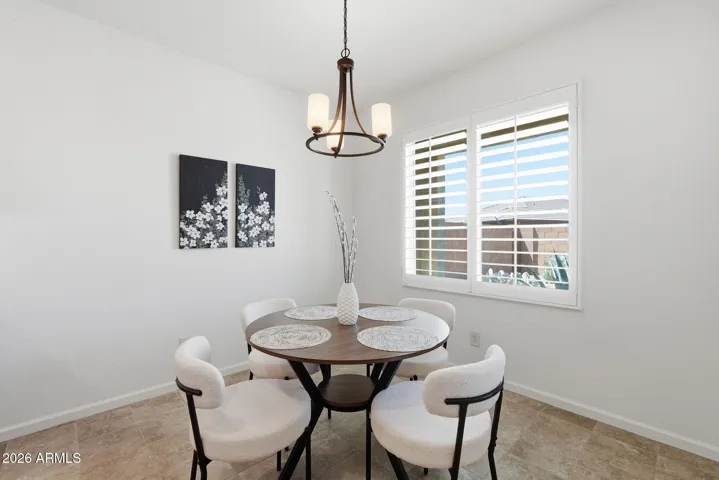 Dining area has lots of natural light and plantation shutters