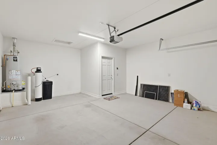 Garage has a water softener and the service door to go out to the walkway