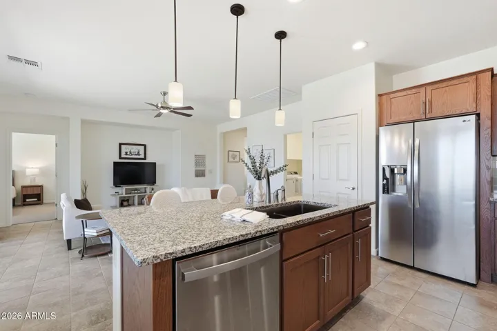 Pendant lighting above the island, stainless steel appliances