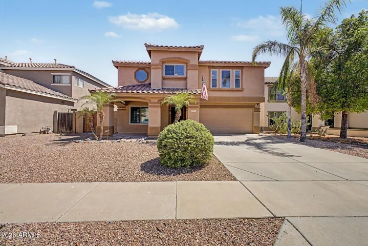 Beautiful two-story home with mature landscaping, extended driveway, and inviting front entry.