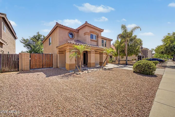 Situated on a generously sized lot with RV gate access and desert landscaping for low maintenance.