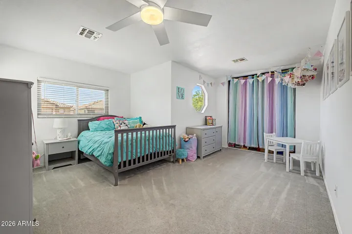 Spacious upstairs bedroom with ample natural light.