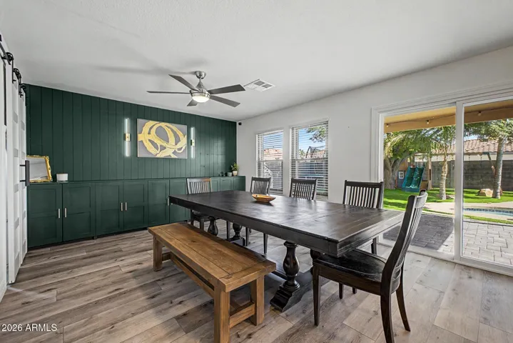 Dining space with cabinet storage, overlooking the resort-style backyard.