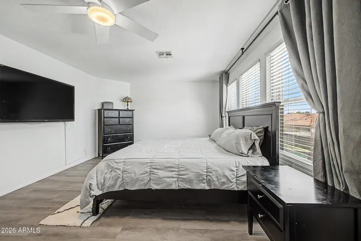 Large primary retreat with abundant natural light and updated flooring.