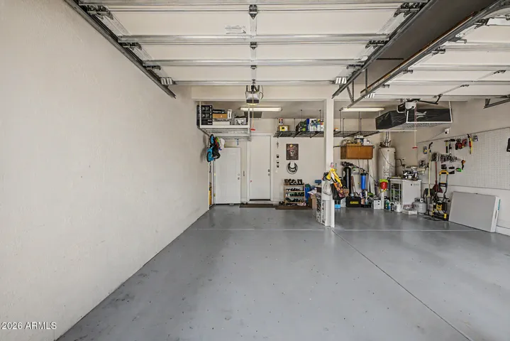 3-car garage is separated into two areas, plenty of overhead storage & EV charging station