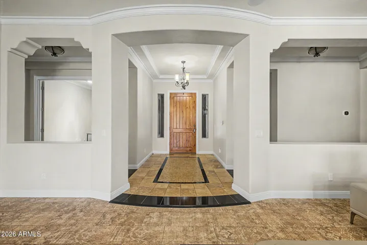 Grand solid wood entry door welcomes you into the foyer