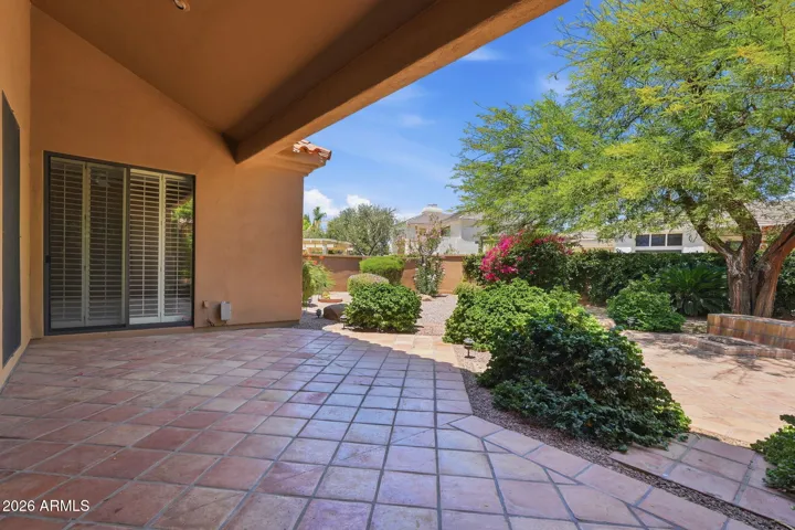 Covered patio and beautiful mature landscaping