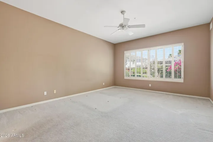 Primary Bedroom is spacious with views of backyard