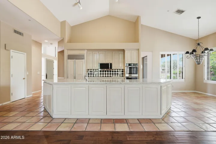 Open plan kitchen with granite countertops, double wall ovens, Subzero refrigerator