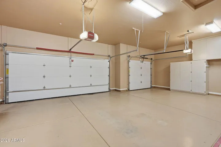 3 car Garage with epoxy floor, cabinets, water softener.