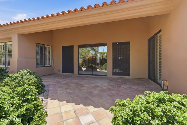 Covered patio and beautiful mature landscaping