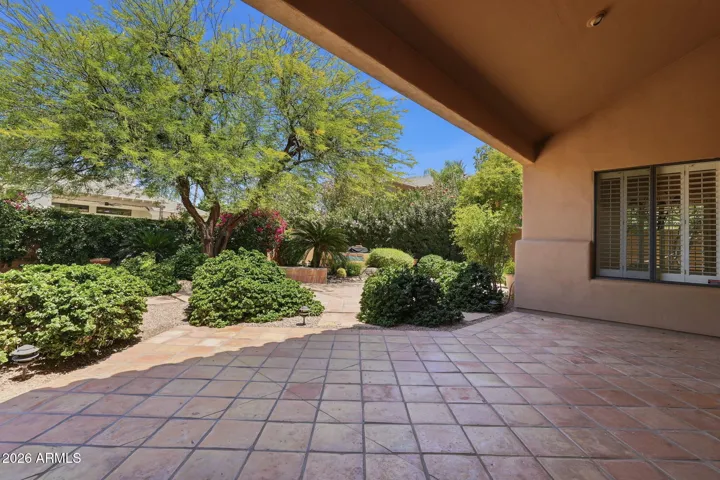 Covered patio and beautiful mature landscaping