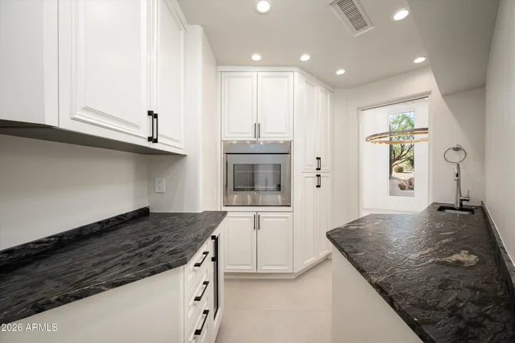 Pass thru to dining room, Thermador oven, Sub- zero wine fridge & Dishwasher