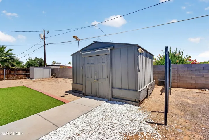 Large backyard with turf, large workshop with power and lighting, storage shed, RV gate & parking, NO HOA, low maintenance.