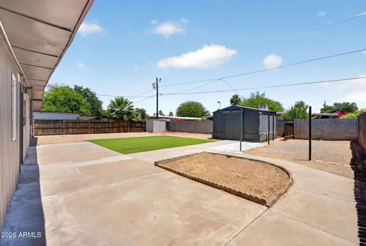 Large backyard with turf, large workshop with power and lighting, storage shed, RV gate & parking, NO HOA, low maintenance.